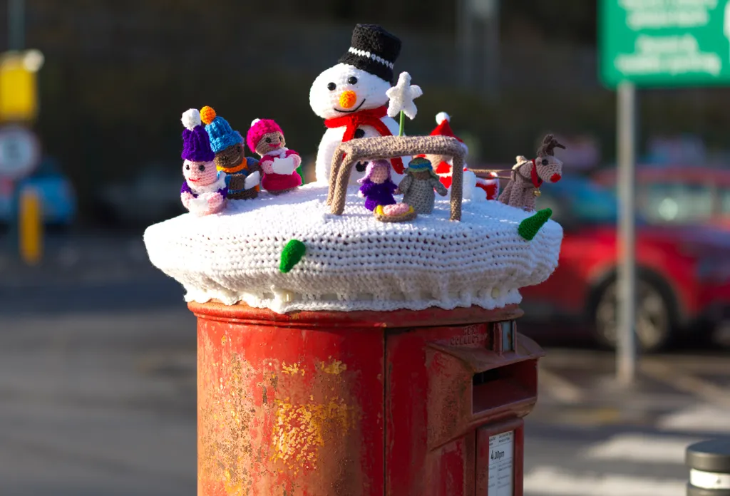 kézzel kötött ünnepi ruha postaládák Anglia Christmas knitted post box topper, Porth, South Wales. Photo released December 18 2023. See SWNS story SWNApostpox. Heartwarming festive snap 