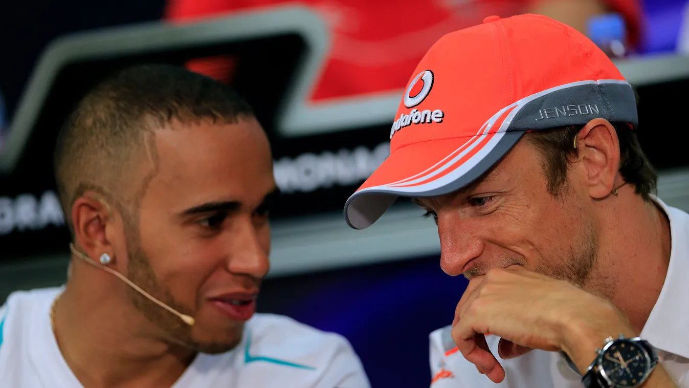 Horizontal Mercedes'  British driver Lewis Hamilton (L) and McLaren Mercedes' British driver Jenson Button sit during a press conference at the Circuit de Monaco in Monte Carlo on May 22, 2013 ahead of the Monaco Formula One Grand Prix.   AFP PHOTO / ALEX