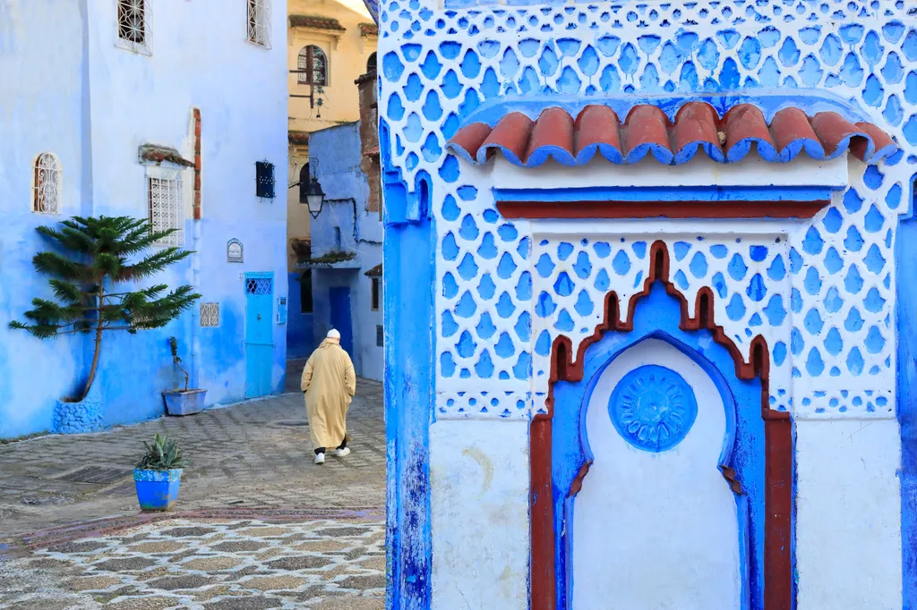 Morocco rif region chefchaouen medina place el haouta fountain man djellaba background