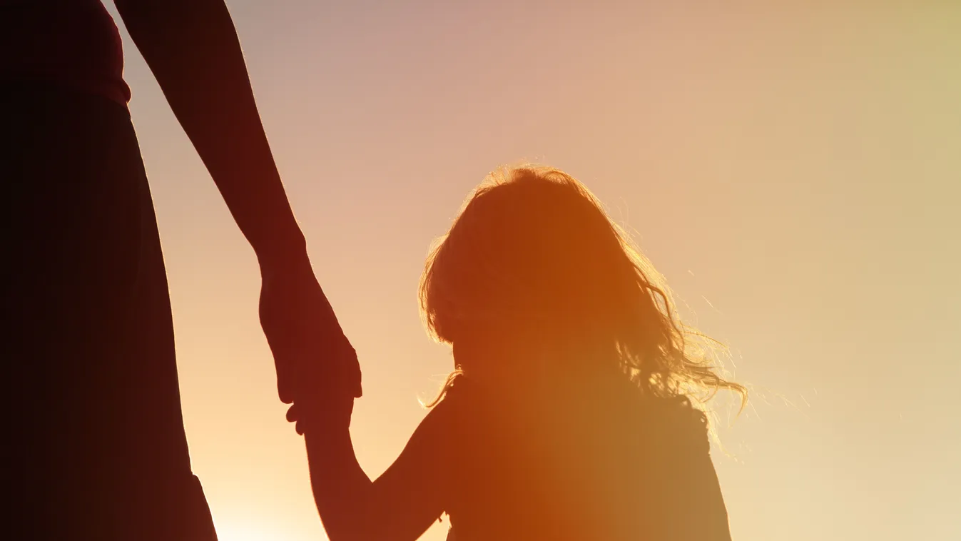 Silhouette,Of,Mother,And,Daughter,Holding,Hands,At,Sunset