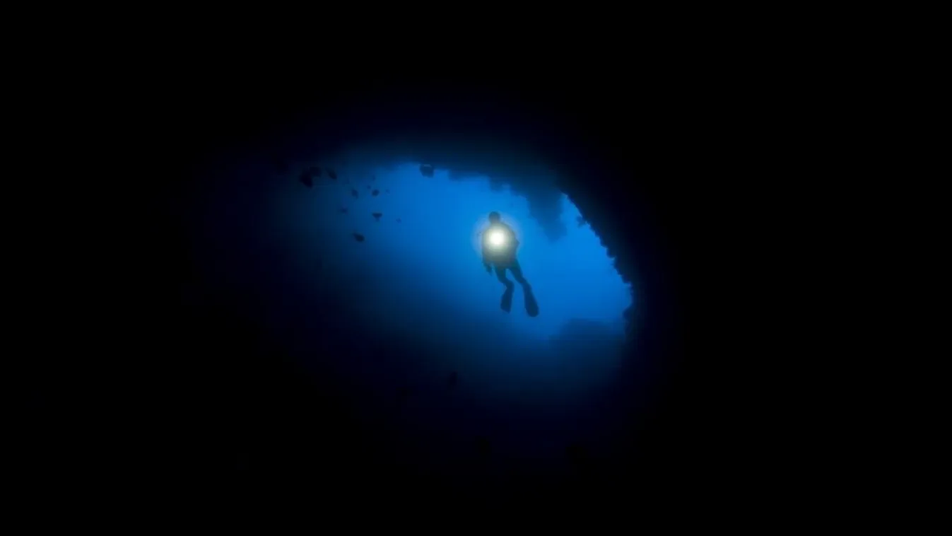 Diver descends into a blue hole - Raja Ampat Indonesia