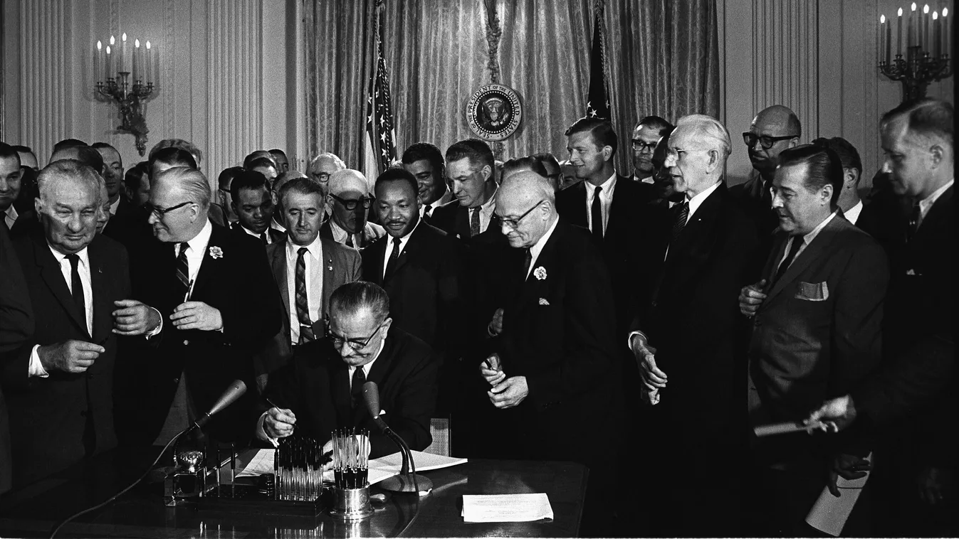 Az amerikai polgárjogi törvény aláírása 1964-ben, ami megtiltotta a faji, vallási, etnikai alapú, valamint a nők elleni diszkriminációt