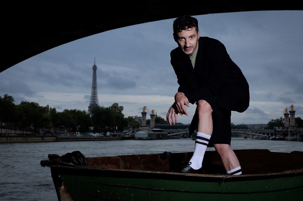 AFP or licensors/(FILES) French Artistic Director for the Opening and Closing Ceremonies of the Paris 2024 Olympic and Paralympic Games Thomas Jolly, poses near the River Seine with The Eiffel Tower in the background in Paris on July 2, 2024. ‘The closer it gets, the happier I get": Thomas Jolly, the artistic orchestrator of the Olympic and Paralympic ceremonies, is a man of the theatre with an overflowing imagination, which he has had to adapt to the restrictive environment of the Paris Games. (Photo by JOEL SAGET / AFP)