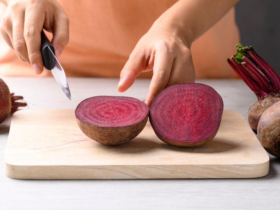 Fresh,Beetroot,On,Cutting,Wooden,Board,With,Hand,,Homemade,Cooking