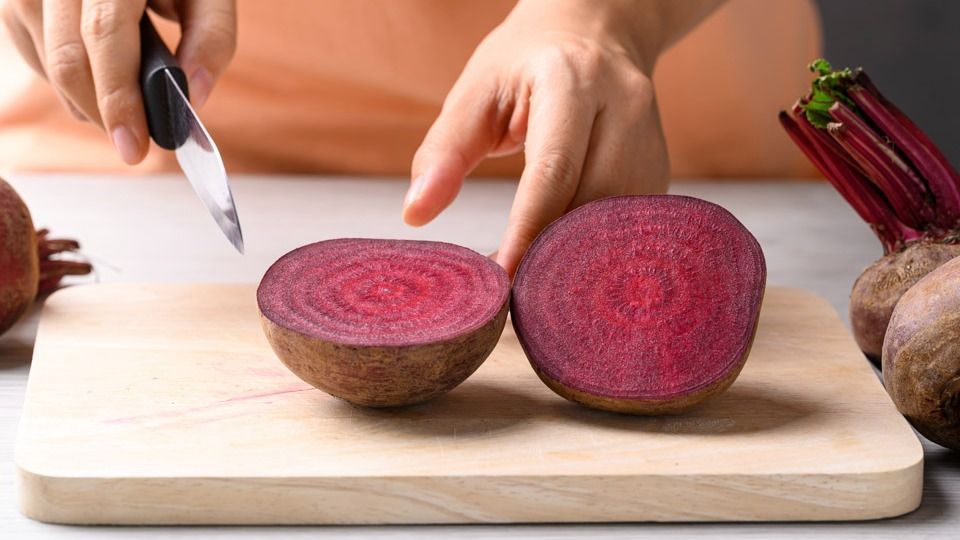 Fresh,Beetroot,On,Cutting,Wooden,Board,With,Hand,,Homemade,Cooking