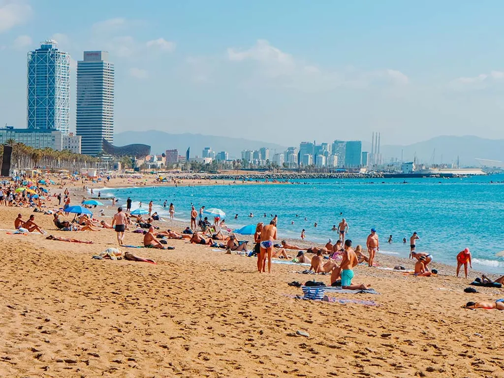 Barcelona,,Spain,-,July,27,,2023:,Bathers,And,Sunbathers,At