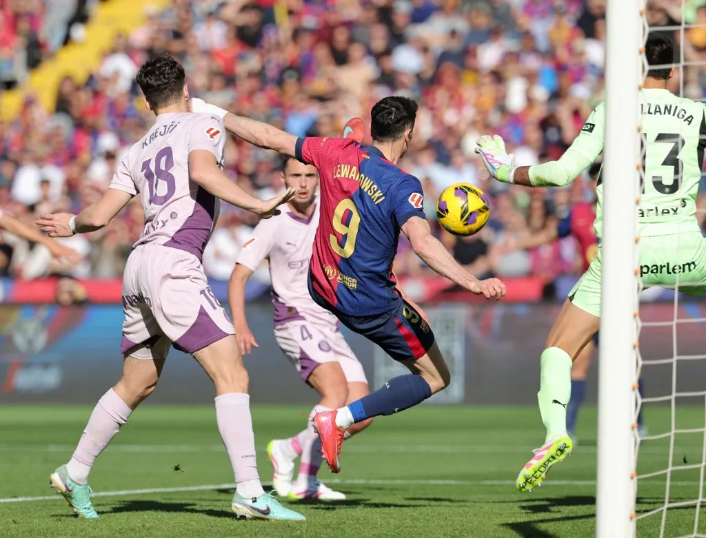 Barcelona's Polish forward #09 Robert Lewandowski scores his team's second goal during the Spanish league football match between FC Barcelona and Girona FC at the Estadi Olimpic Lluis Companys in Barcelona on March 30, 2025. (Photo by LLUIS GENE / AFP)