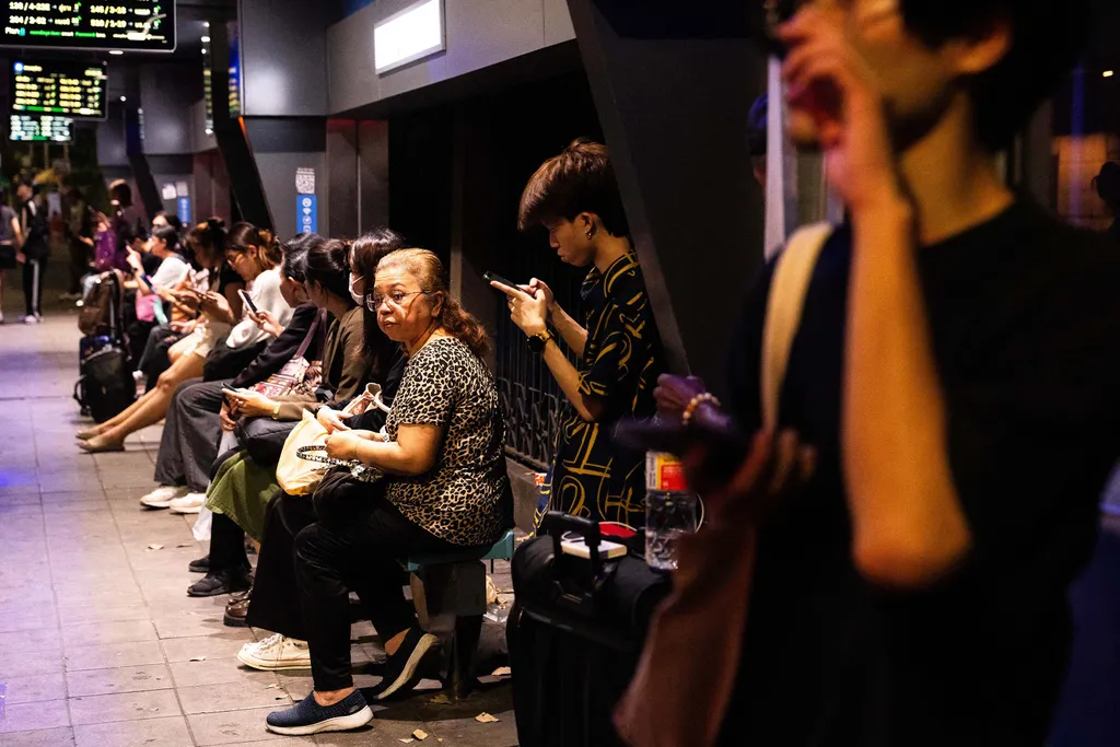 People wait at a bus station in Bangkok on March 28, 2025, after an earthquake. A huge earthquake hit Myanmar and Thailand on March 28, killing more than 150 people and injuring hundreds, with dozens trapped in collapsed buildings and the death toll expec