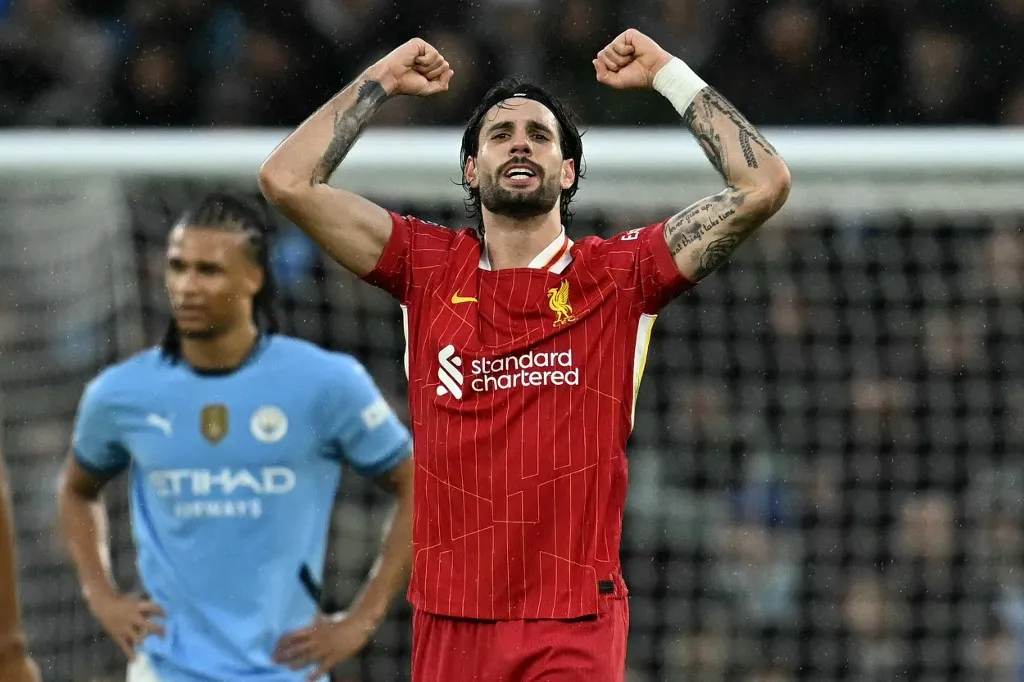 Liverpool's Hungarian midfielder #08 Dominik Szoboszlai (C) celebrates scoring the team's second goal during the English Premier League football match between Manchester City and Liverpool at the Etihad Stadium in Manchester, north west England, on Februa