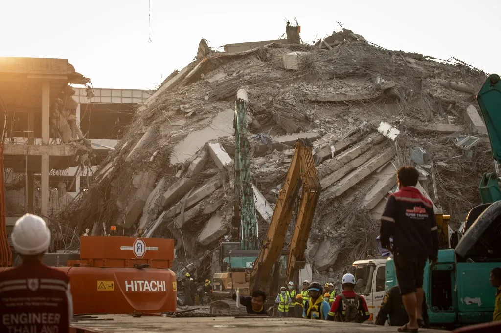 BANGKOK, THAILAND - MARCH 29: Rescue teams work tirelessly amidst the rubble of a collapsed skyscraper in Bangkok’s Chatuchak district following an earthquake in Bangkok, Thailand on March 29, 2025. Day 2 after a 7.7-magnitude earthquake struck central Myanmar on March 28, 2025, Bangkok reels from the collapse of a 33-story skyscraper under construction. Rescue teams have saved seven survivors so far, but 47 to 90 people—mostly workers—remain trapped under the rubble, with vital signs detected for about 15. The death toll in Bangkok stands at 8, as families wait anxiously amidst ongoing efforts. Guillaume Payen / Anadolu (Photo by Guillaume Payen / ANADOLU / Anadolu via AFP)