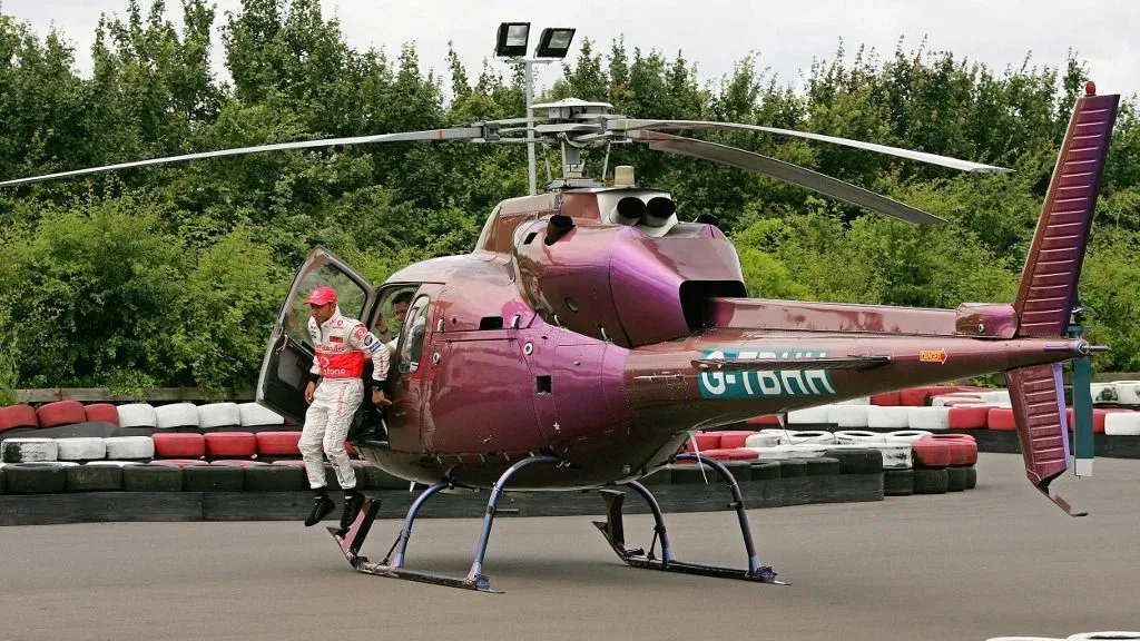 British F1 racing driver Lewis Hamilton jumps from his helicopter as he prepares to race in a go-kart at the Daytona International karting track, in Milton Keynes, in southern England, 05 July 2007. World championship leading British rookie Lewis Hamilton hopes to sweep controversy aside this weekend by winning his home Grand Prix and extending his lead in the drivers' title race. The 22-year-old Englishman, the first driver of Afro-Caribbean descent to race and win in Formula One, has a 14-points lead ahead of his McLaren Mercedes-Benz team-mate defending champion Fernando Alonso of Spain. AFP PHOTO/CARL DE SOUZA (Photo by CARL DE SOUZA / AFP), Lewis Hamilton