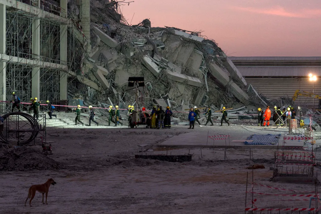 Rescue teams operate at a construction site where a building collapsed in Bangkok on March 28, 2025, following an earthquake. A powerful earthquake killed more than 20 people across Myanmar and Thailand on March 28, toppling buildings and bridges and trap