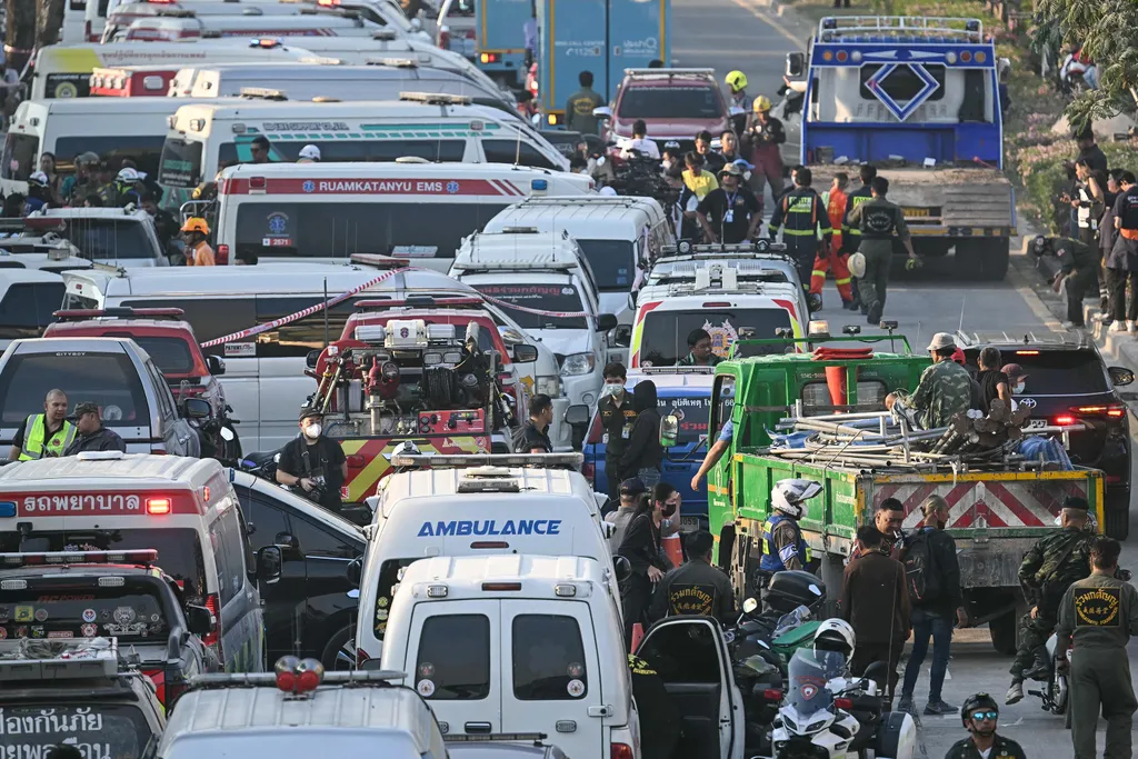 Emergency services are seen amid traffic near a construction site where a building collapsed in Bangkok on March 28, 2025, after an earthquake. A massive earthquake on March 28 turned a major hospital in Myanmar's capital into a "mass casualty area", whil