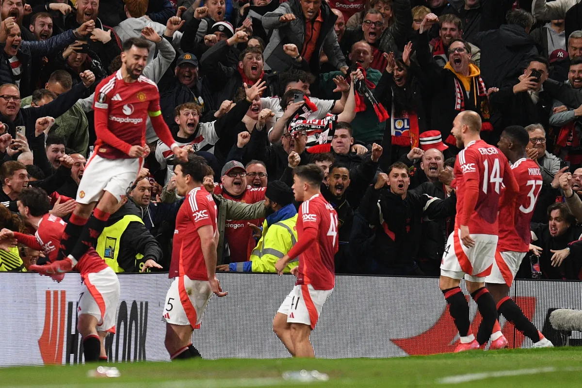 Manchester United's English defender #05 Harry Maguire (2L) and teammates celebrate with their fans after Maguire scores their fifth goal during the UEFA Europa league quarter-final final, second leg football match between Manchester United and Lyon at Old Trafford stadium in Manchester, north west England, on April 17, 2025. (Photo by Oli SCARFF / AFP)