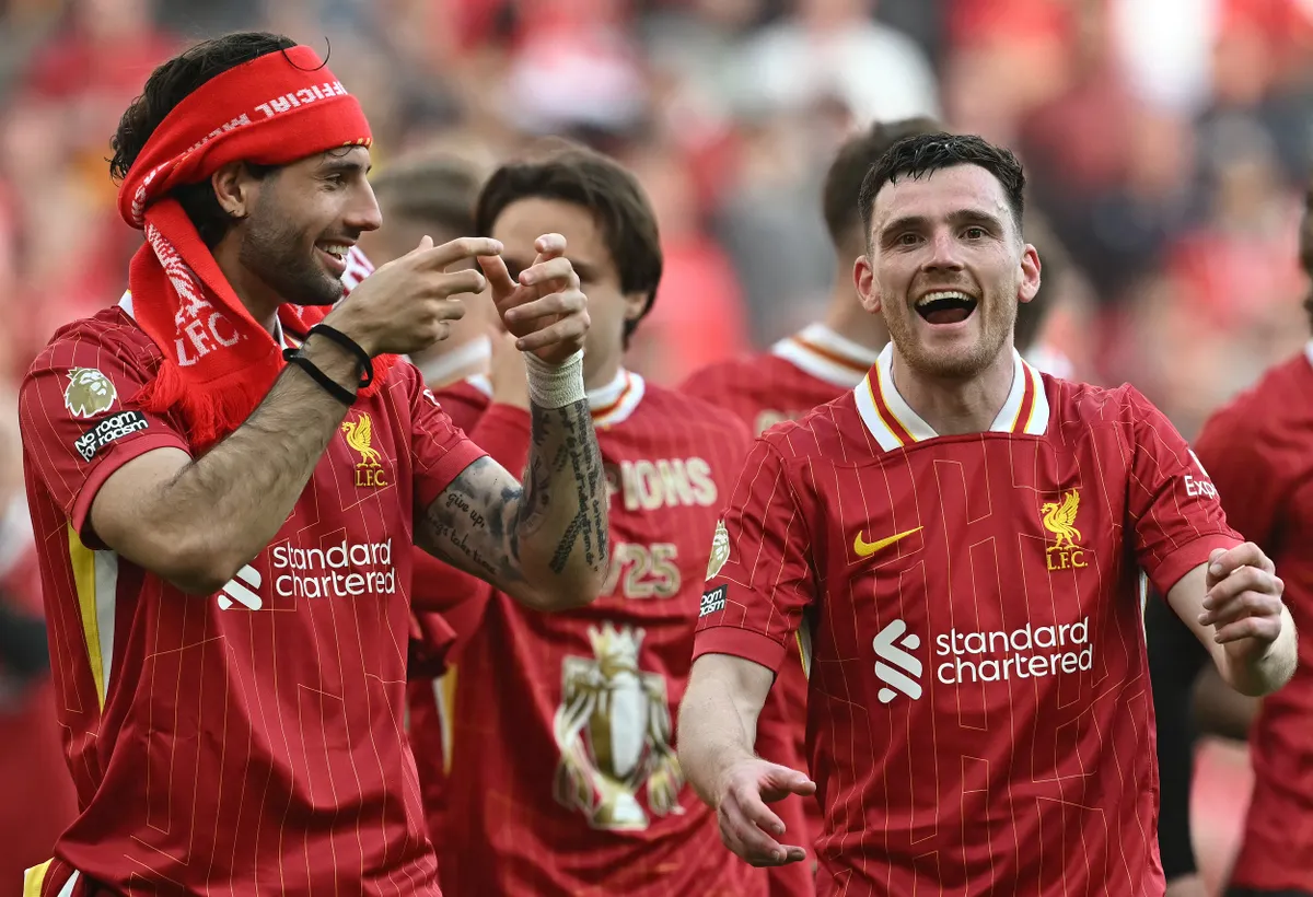 Liverpool's Hungarian midfielder #08 Dominik Szoboszlai (L) and Liverpool's Scottish defender #26 Andrew Robertson celebrate after the English Premier League football match between Liverpool and Tottenham Hotspur at Anfield in Liverpool, north west England on April 27, 2025. Liverpool won the match 5-1, making them the winners of the Premier League title. (Photo by Paul ELLIS / AFP) / RESTRICTED TO EDITORIAL USE. No use with unauthorized audio, video, data, fixture lists, club/league logos or 'live' services. Online in-match use limited to 120 images. An additional 40 images may be used in extra time. No video emulation. Social media in-match use limited to 120 images. An additional 40 images may be used in extra time. No use in betting publications, games or single club/league/player publications. /