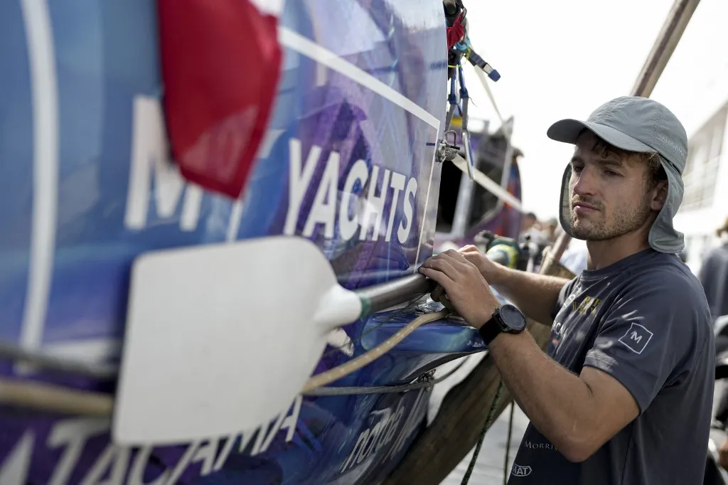Scotland's Ewan Maclean prepares his boat before setting sail with his brothers for Australia from Callao, in the Lima metropolitan area, on April 12, 2025. Three brothers from Scotland set sail for Sydney this Saturday from Callao, Peru's main seaport near Lima, with the challenge of rowing nonstop across the Pacific Ocean and raising more than $1 million for clean water projects in Madagascar. (Photo by John REYES / AFP)