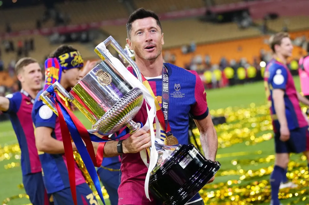 Robert Lewandowski centre-forward of Barcelona and Poland celebrates with the trophy after winning the Copa del Rey Final match between FC Barcelona and Real Madrid at Estadio de La Cartuja on April 26, 2025 in Seville, Spain. (Photo by Jose Breton/Pics Action/NurPhoto) (Photo by Jose Breton / NurPhoto / NurPhoto via AFP)
