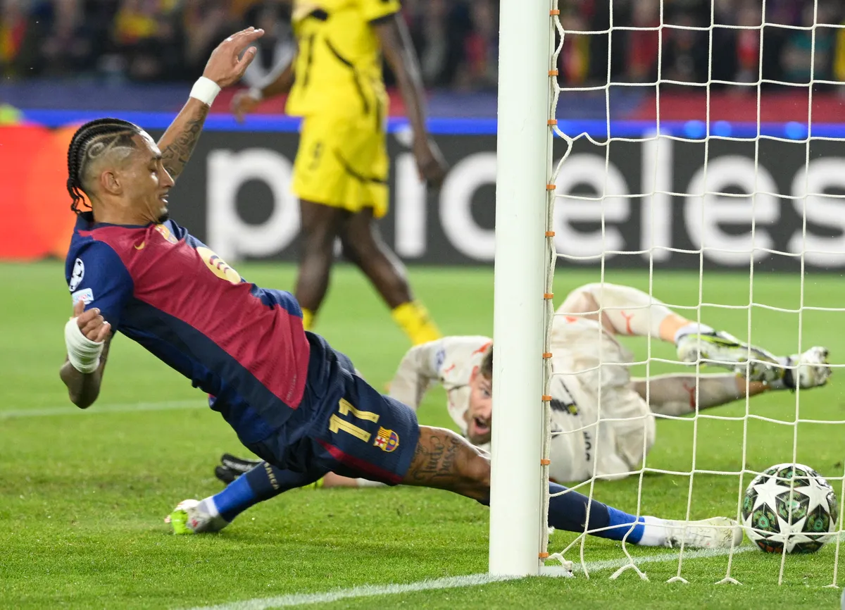 Barcelona's Brazilian forward #11 Raphinha scores the opening goal during the UEFA Champions League Quarter final First Leg football match between FC Barcelona and BVB Borussia Dortmund  at the Estadi Olimpic Lluis Companys in Barcelona on April 9, 2025. (Photo by Josep LAGO / AFP)