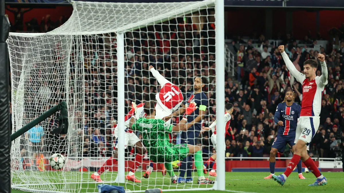 Arsenal's German midfielder #29 Kai Havertz (R) celebrates the team's second goal during the UEFA Champions League football match between Arsenal and Paris Saint-Germain (PSG) at the Emirates Stadium in north London on October 1, 2024. (Photo by Adrian Dennis / AFP)