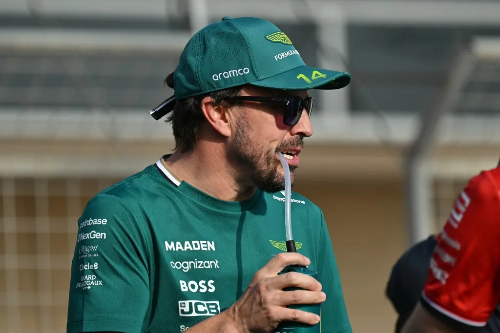 Aston Martin's Spanish driver Fernando Alonso looks on during the drivers parade for the Bahrain Formula One Grand Prix at the Bahrain International Circuit in Sakhir on April 13, 2025. (Photo by Andrej ISAKOVIC / AFP)