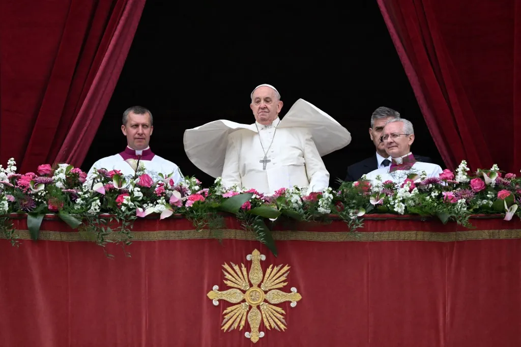 Pope Francis stands at the central loggia of St. Peter's basilica for the Easter 'Urbi et Orbi' message and blessing to the City and the World as part of the Holy Week celebrations, in the Vatican on March 31, 2024. (Photo by Tiziana FABI / AFP)