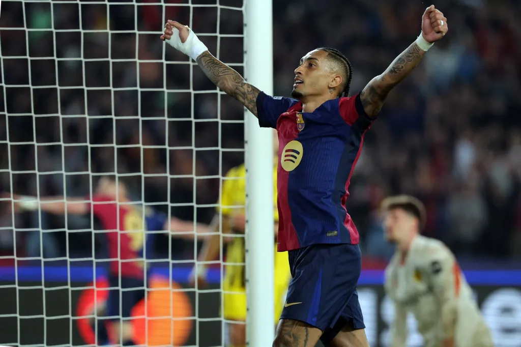 Barcelona's Brazilian forward #11 Raphinha celebrates his team's third goal during the UEFA Champions League Quarter final First Leg football match between FC Barcelona and BVB Borussia Dortmund  at the Estadi Olimpic Lluis Companys in Barcelona on April 9, 2025. (Photo by LLUIS GENE / AFP)