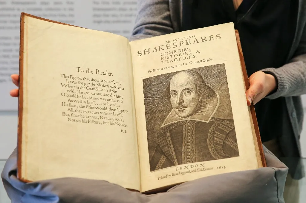 LONDON, UNITED KINGDOM - MAY 18: A gallery staff holds William Shakespeare's First Folio at 'Firsts: London’s Rare Book Fair' held at Saatchi Gallery in central London, United Kingdom on May 18, 2023. The First Folio contains all 36 of Shakespeare's plays. The 66th rare book fair runs between 18 - 21 May 2023 at Saatchi Gallery. Dinendra Haria / Anadolu Agency (Photo by Dinendra Haria / ANADOLU AGENCY / Anadolu via AFP)