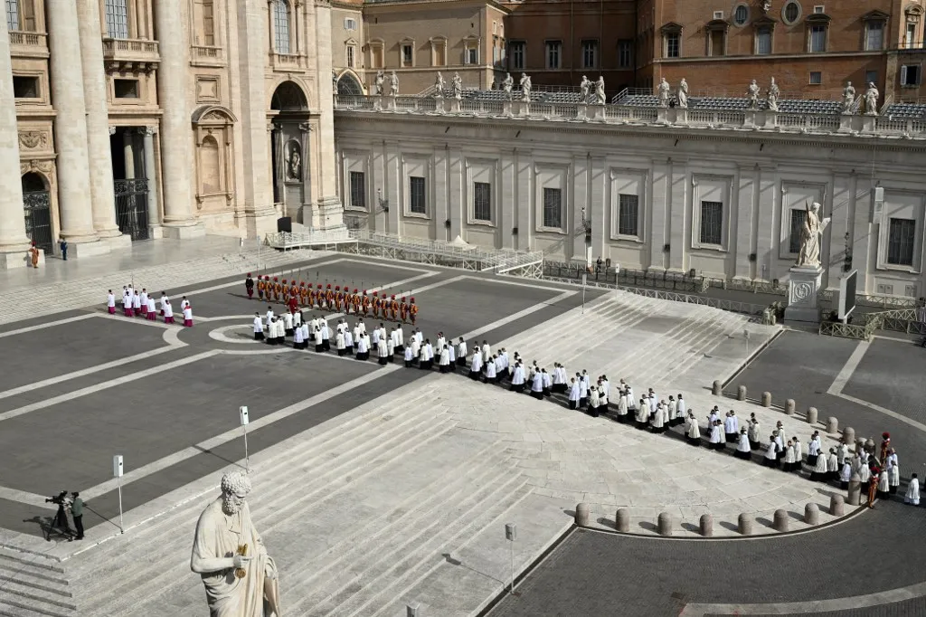 Members of the clergy walk in a line during the procession of the coffin of the late Pope from the chapel of Santa Marta to St Peter's Basilica, following the Pope's death, in the Vatican on April 23, 2025. The Pope died of a stroke, the Vatican announced hours after the death on April 21, 2025, of the 88-year-old reformer who inspired devotion but riled traditionalists during 12 years leading the Catholic Church. (Photo by Alberto PIZZOLI / AFP)