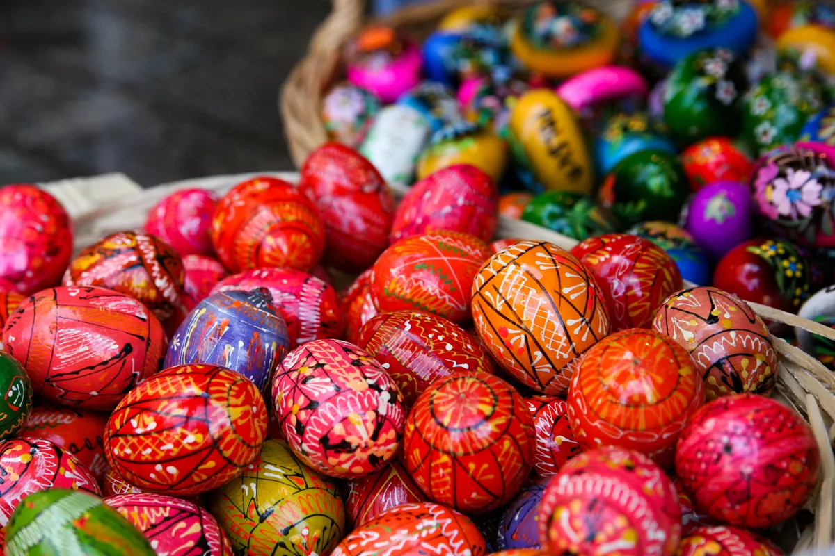 Hand-painted wooden Easter eggs are being displayed at the Easter fair on the Main Square in Krakow, Poland, on March 24, 2024. Palm Sunday, which marks the beginning of Holy Week in Christianity, commemorates the arrival of Jesus in Jerusalem. Traditionally, handmade palm trees are being blessed on this day, and competitions are being organized for the most beautiful palm. (Photo by Klaudia Radecka/NurPhoto) (Photo by Klaudia Radecka / NurPhoto / NurPhoto via AFP)
