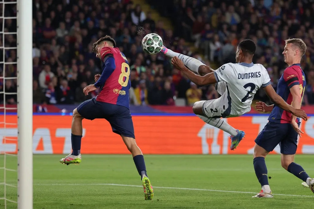 Inter Milan's Dutch defender #02 Denzel Dumfries scores his team's second goal during the UEFA Champions League semi final first leg football match between FC Barcelona and Inter Milan at the Estadi Olimpic Lluis Companys in Barcelona on April 30, 2025. (Photo by LLUIS GENE / AFP)