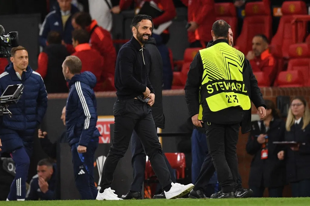 Manchester United's Portuguese head coach Ruben Amorim smiles as he leaves after the UEFA Europa league quarter-final final, second leg football match between Manchester United and Lyon at Old Trafford stadium in Manchester, north west England, on April 17, 2025. United won the game 5-4 after extra time, and the tie 7-6 on aggregate. (Photo by Oli SCARFF / AFP)