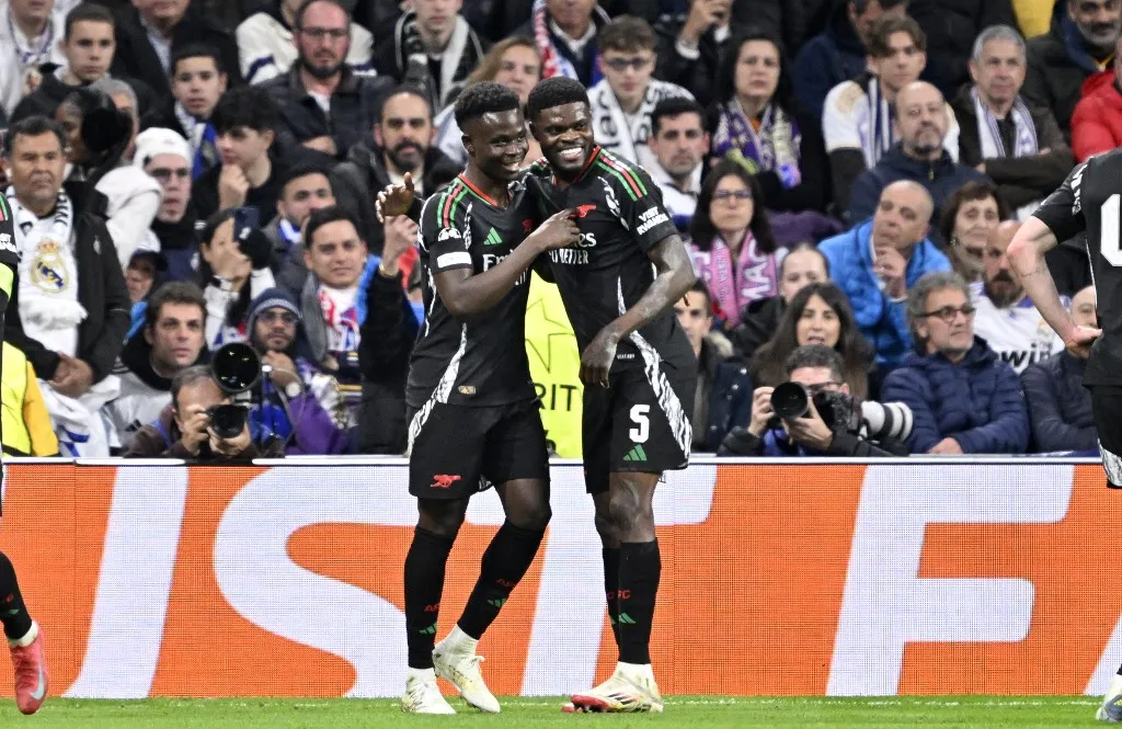 MADRID, SPAIN - APRIL 16: Bukayo Saka of Arsenal celebrates with his teammates after a goal during the UEFA Champions League quarter-final second-leg match between Real Madrid and Arsenal at Santiago Bernabeu Stadium in Madrid, Spain on April 16, 2025. Burak Akbulut / Anadolu (Photo by BURAK AKBULUT / ANADOLU / Anadolu via AFP)