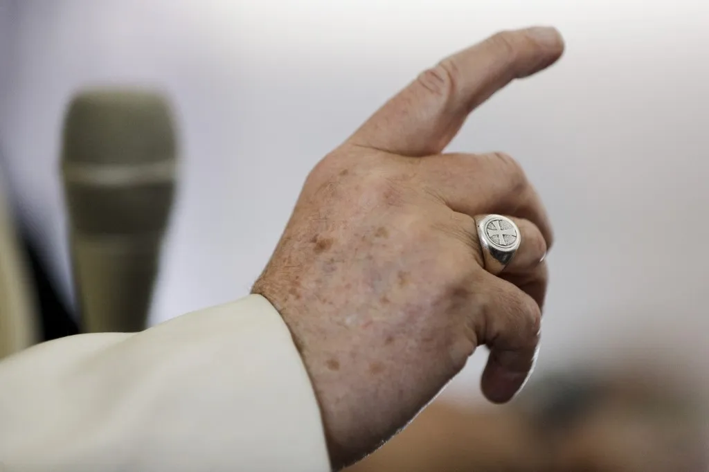 A close-up view shows Pope Francis' hand and ring as he talks to reporters during a press conference in flight aboard the plane taking him back from Sibiu, Romania, to Rome, on June 2, 2019 after a three-day visit to Romania. (Photo by Andrew Medichini / POOL / AFP)