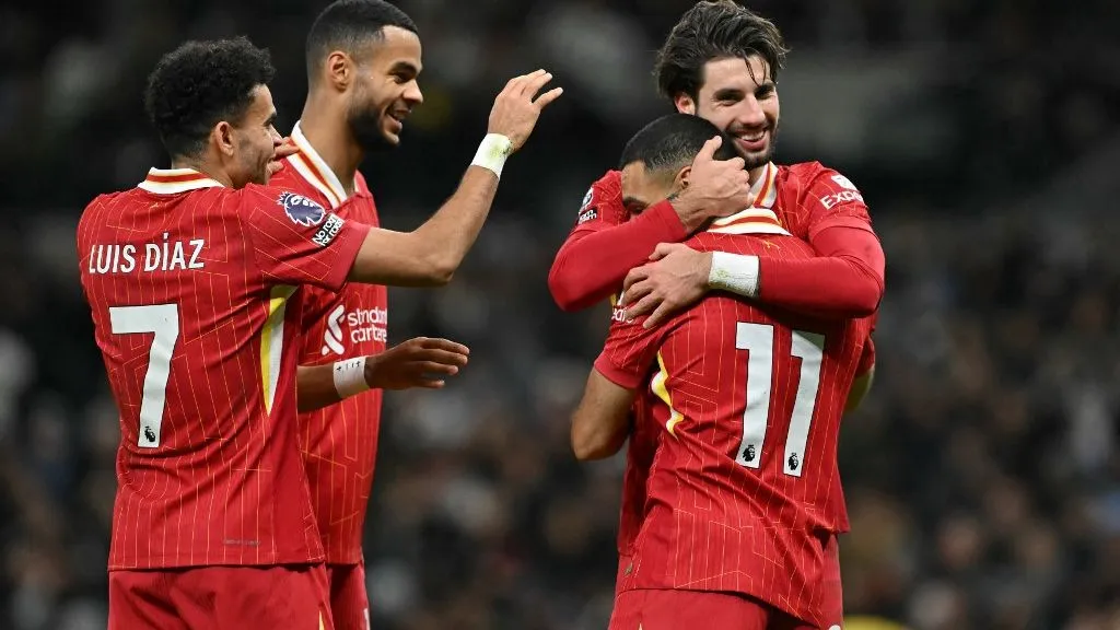 Liverpool's Egyptian striker #11 Mohamed Salah (2R) celebrates with Liverpool's Hungarian midfielder #08 Dominik Szoboszlai (R), Liverpool's Colombian midfielder #07 Luis Diaz (L) and Liverpool's Dutch striker #18 Cody Gakpo (2L) after scoring their fifth goal during the English Premier League football match between Tottenham Hotspur and Liverpool at the Tottenham Hotspur Stadium in London, on December 22, 2024. (Photo by Glyn KIRK / AFP) / RESTRICTED TO EDITORIAL USE. No use with unauthorized audio, video, data, fixture lists, club/league logos or 'live' services. Online in-match use limited to 120 images. An additional 40 images may be used in extra time. No video emulation. Social media in-match use limited to 120 images. An additional 40 images may be used in extra time. No use in betting publications, games or single club/league/player publications. / 