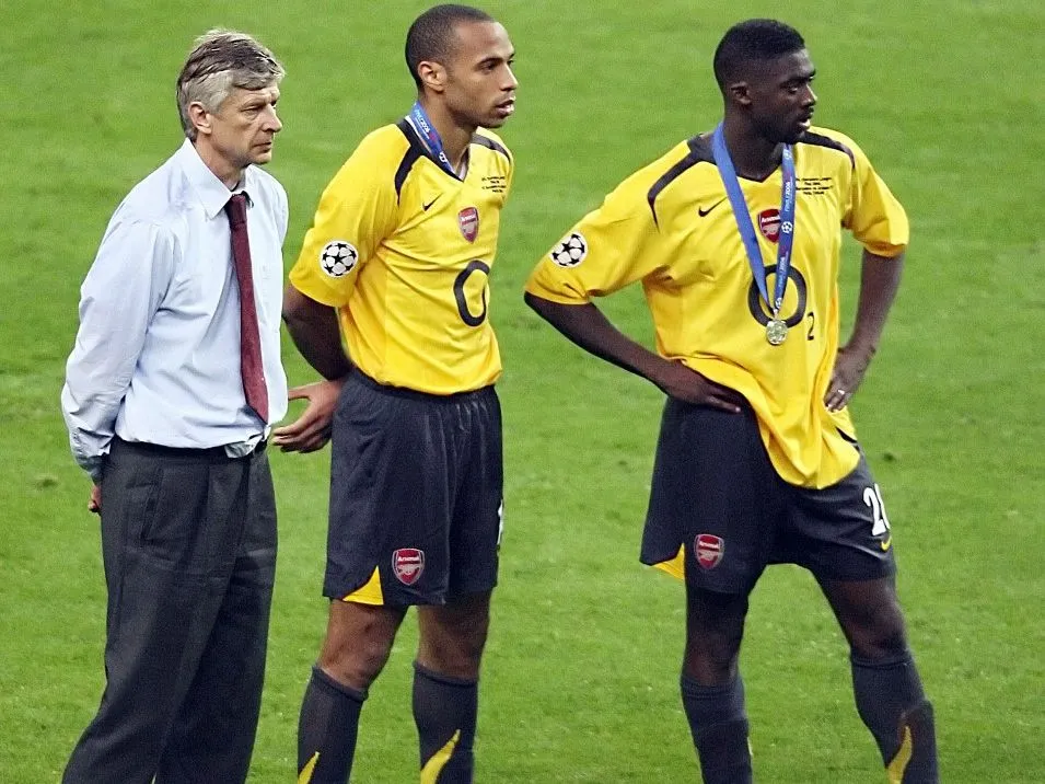 Arsenal's French forward and team captain Thierry Henry (C), Arsenal's French coach Arsene Wenger (L) and Arsenal's Ivorian defender Kolo Abib Toure look at the trophy ceremony after loosing the UEFA Champion's League final football match against Barcelona, 17 May 2006 at the Stade de France in Saint-Denis, northern Paris. Barcelona won 2 to 1.  AFP PHOTO GABRIEL BOUYS (Photo by GABRIEL BOUYS / AFP)
