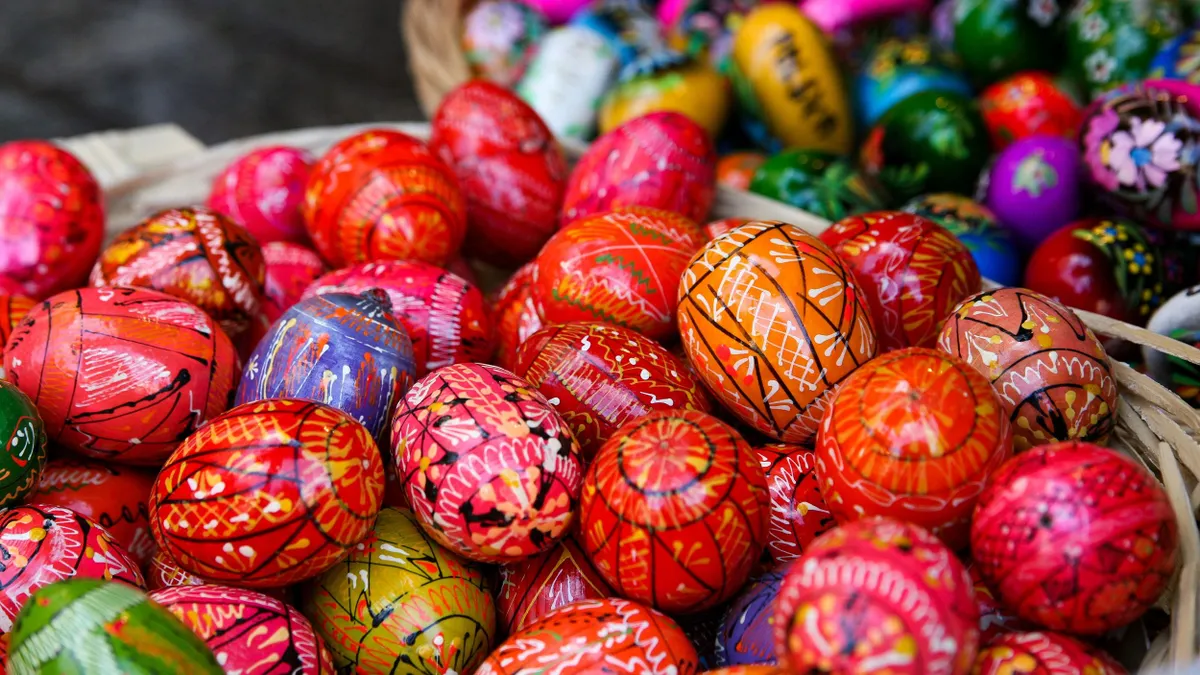 Hand-painted wooden Easter eggs are being displayed at the Easter fair on the Main Square in Krakow, Poland, on March 24, 2024. Palm Sunday, which marks the beginning of Holy Week in Christianity, commemorates the arrival of Jesus in Jerusalem. Traditionally, handmade palm trees are being blessed on this day, and competitions are being organized for the most beautiful palm. (Photo by Klaudia Radecka/NurPhoto) (Photo by Klaudia Radecka / NurPhoto / NurPhoto via AFP)