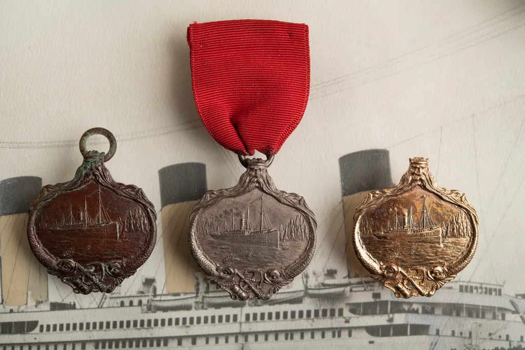 BNPS.co.uk (01202 558833)
Pic: ZacharyCulpin/BNPS

Pictured: The Gold (right), silver (centre) and bronze (left) decorations

Gold, silver and bronze medals awarded to crew members of the ship that rescued 700 Titanic survivors have been brought together 