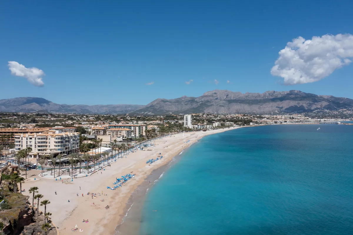 Aerial photo of the Spanish town of L'Albir in Spain showing the beach front on a sunny summers day