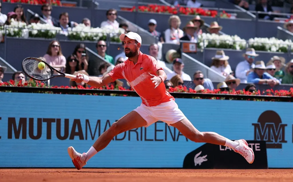 Serbia's Novak Djokovic returns the ball to Italy's Matteo Arnaldi  during their 2025 ATP Tour Madrid Open tennis tournament second round singles match at the Caja Magica in Madrid, on April 26, 2025. (Photo by Thomas COEX / AFP)