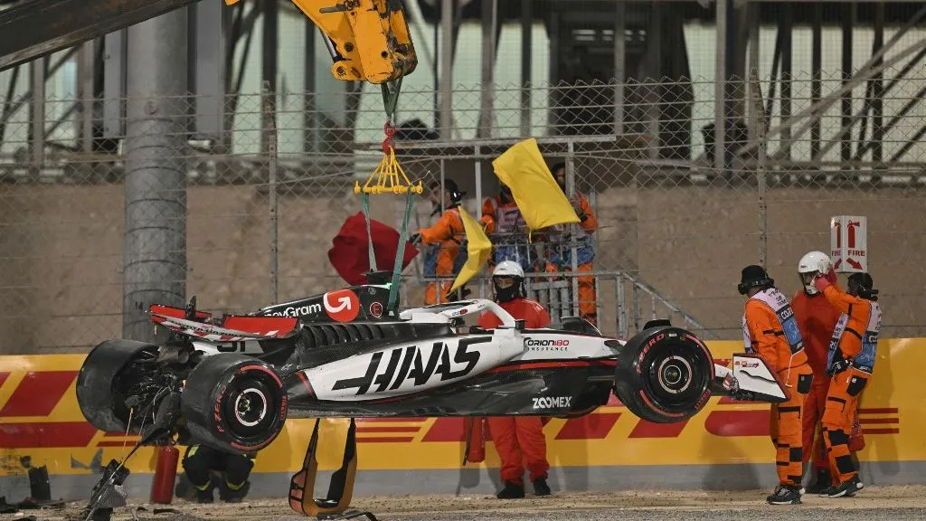 A crane lifts the car of Haas F1 Team's French driver Esteban Ocon during the qualifying session ahead of the Bahrain Formula One Grand Prix at the Bahrain International Circuit in Sakhir on April 12, 2025. (Photo by Andrej ISAKOVIC / AFP)
