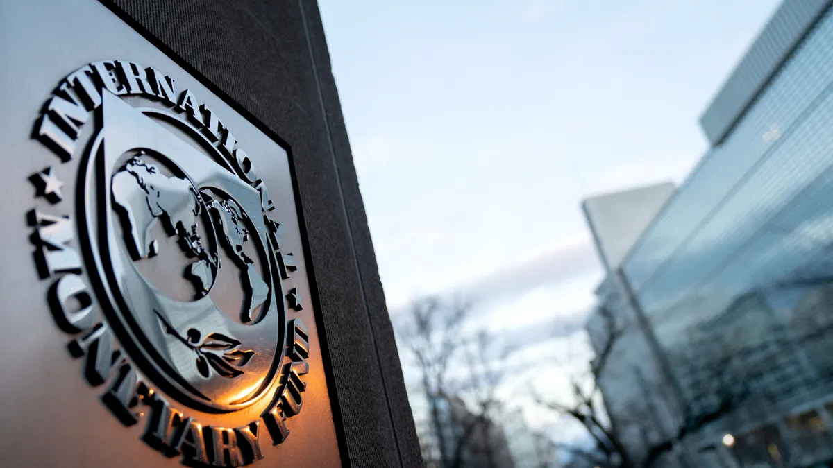 The seal for the International Monetary Fund is seen near the World Bank headquarters (R) in Washington, DC on January 10, 2022. (Photo by Stefani Reynolds / AFP)