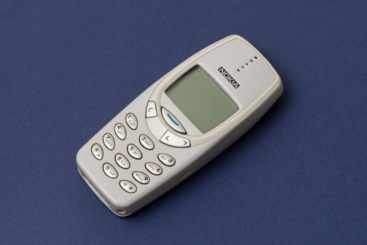 ISTANBUL, TURKEY - DECEMBER 18 2021: Cell phone Nokia 3310 on the blue background.