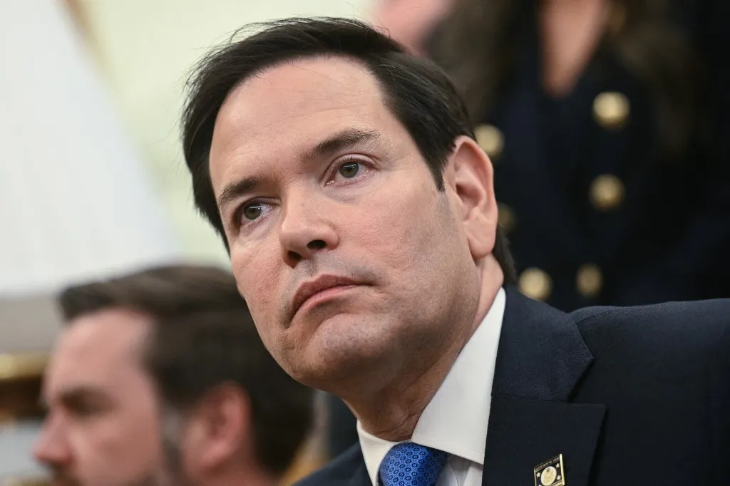 US Secretary of State Marco Rubio listens as President Donald Trump meets with El Salvador's President Nayib Bukele in the Oval Office of the White House in Washington, DC, April 14, 2025. Trump on Monday hosted El Salvador's President Nayib Bukele, the self-described "world's coolest dictator" who is now the US leader's key ally in a controversial push to deport illegal migrants to a notorious Salvadoran prison. The meeting comes as the White House faces pressure over the case of a father who was mistakenly deported to the jail in the Central American country -- whose return a US court has ordered the Trump adminstration to facilitate (Photo by Brendan SMIALOWSKI / AFP)
