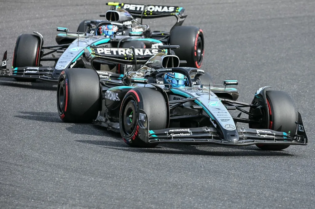 Mercedes' British driver George Russell (front R) leads teammate Mercedes' Italian driver Andrea Kimi Antonelli (behind) around a corner during the qualifying session of the Formula One Japanese Grand Prix at the Suzuka circuit in Suzuka, Mie prefecture on April 5, 2025. (Photo by Toshifumi KITAMURA / AFP)