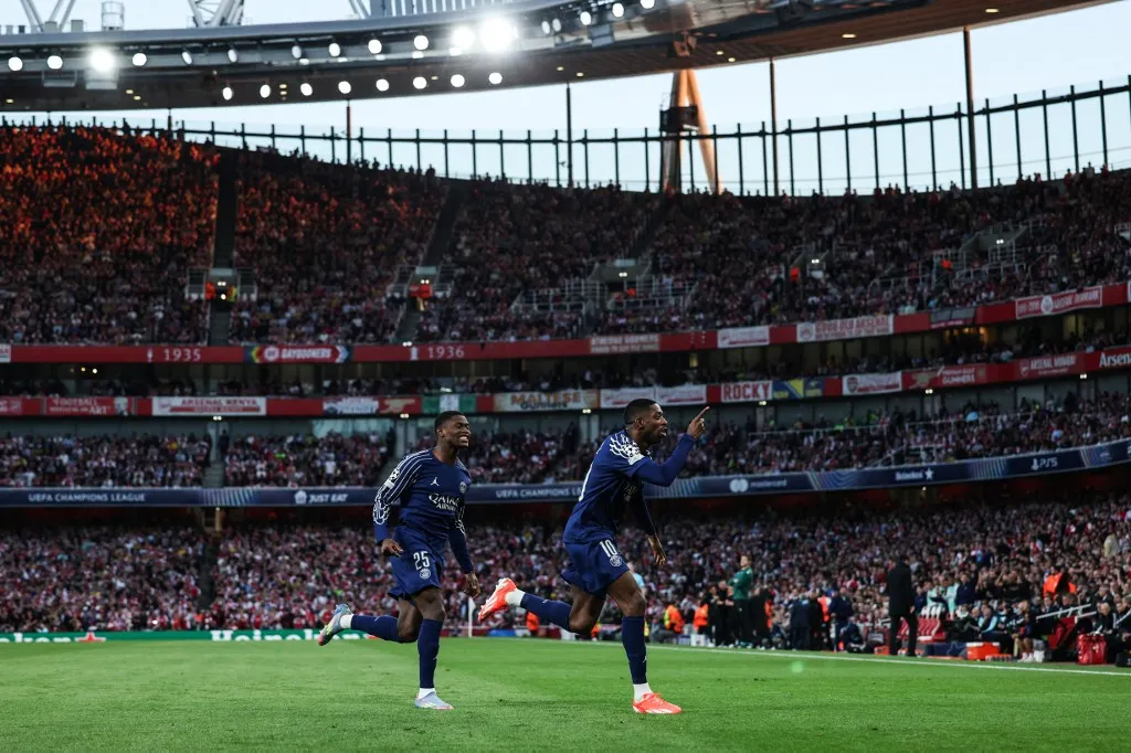 Paris Saint-Germain's French forward #10 Ousmane Dembele (R) celebrates after scoring his team first goal during the UEFA Champions League Semi-final First Leg football match between Arsenal and Paris Saint-Germain (PSG) at the Emirates Stadium in north London, on April 29, 2025. (Photo by Adrian Dennis / AFP)