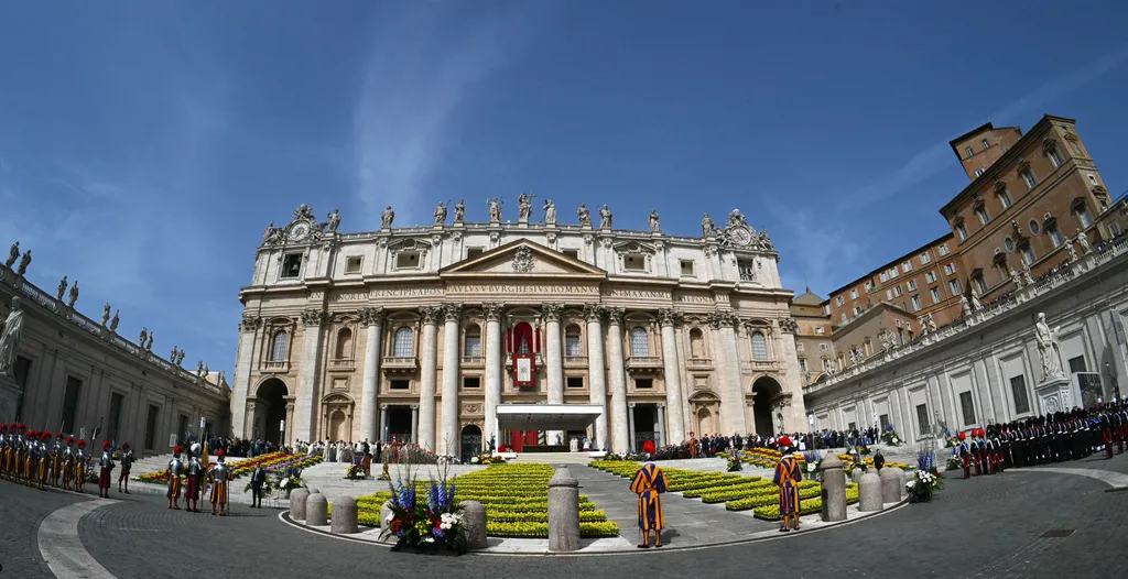 Flowers adorn the parvis of the basilica during the Easter Mass as part of the Holy Week celebrations, at St Peter's square in the Vatican on April 20, 2025. (Photo by Andreas SOLARO / AFP)