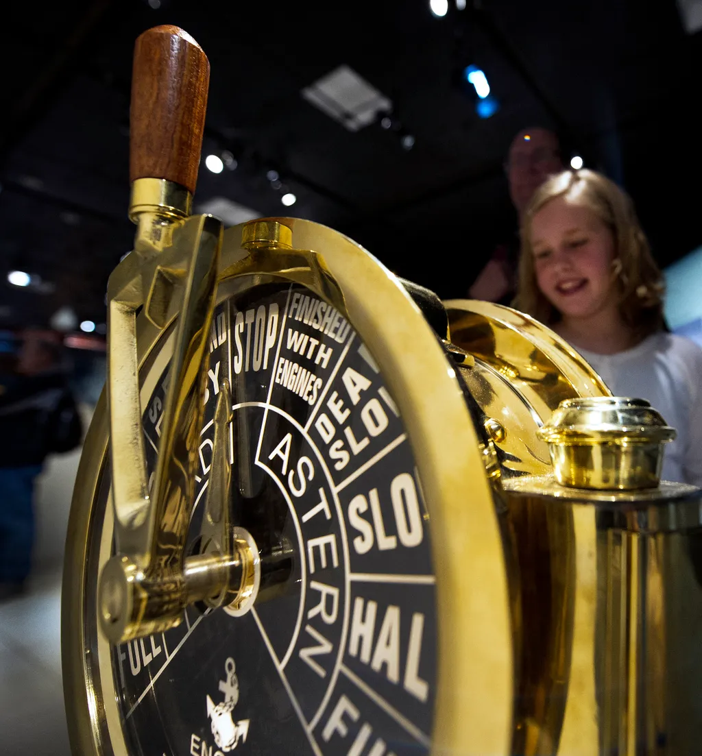 Hannah from Chicago looks over the ship's engine room telegraph as she enjoys National Geographic's "Titanic: 100Year Obsession", on the first day it is opened to the public  March 29, 2012, in Washington, DC.       The National Geographic Museum unveils 