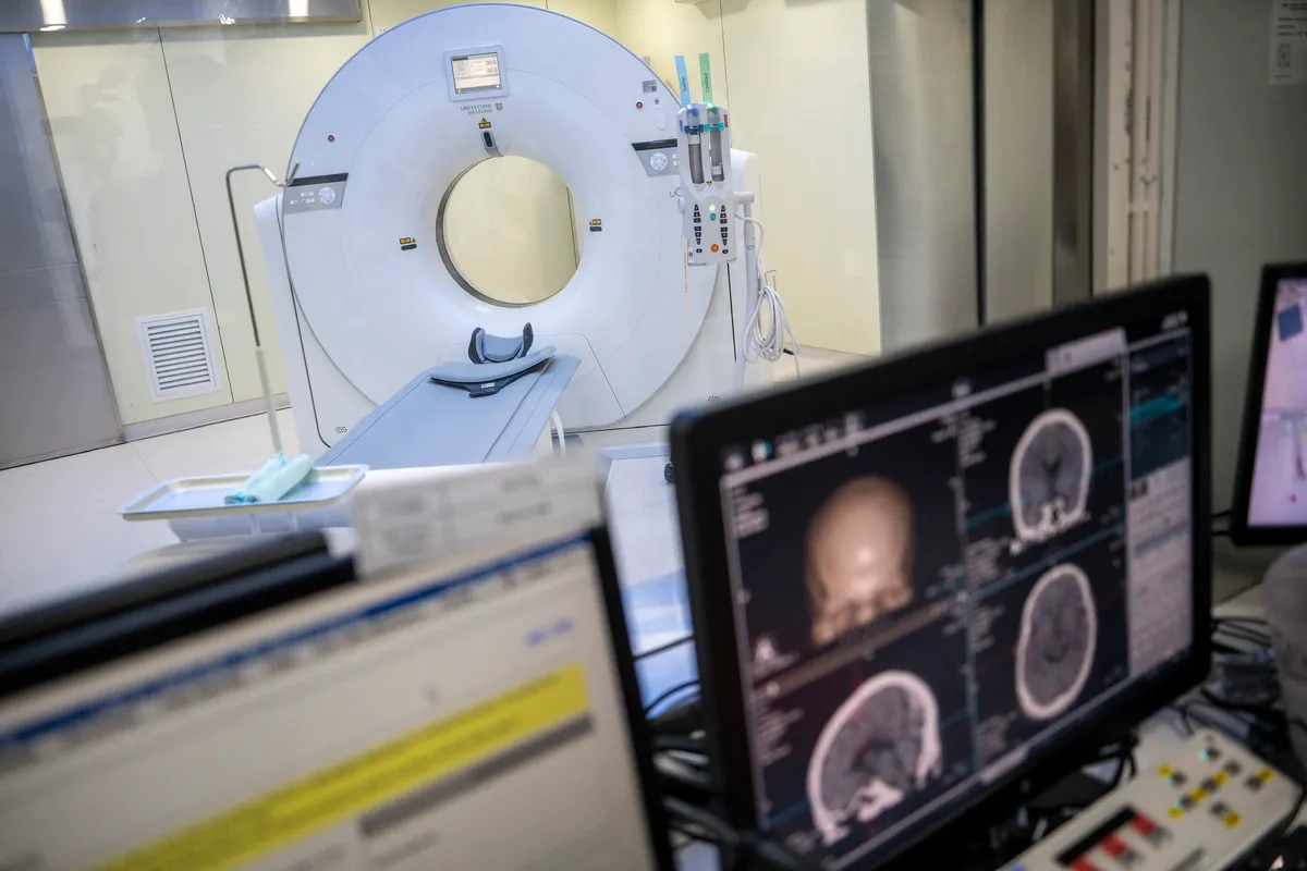 A General view showing a CT Scanner with a screen showing a ct scan of a brain inside the Central Government-aided Emergency Hospital on July 11, 2023 in Hong Kong, China. The Hospital Authority (HA) launched the Ambulatory Diagnosic Radiology Service Plot Programme at the Central Govemment-aided Emergency Hospital in Lok Ma Chau. (Photo by Vernon Yuen/NurPhoto) (Photo by Vernon Yuen / NurPhoto / NurPhoto via AFP)