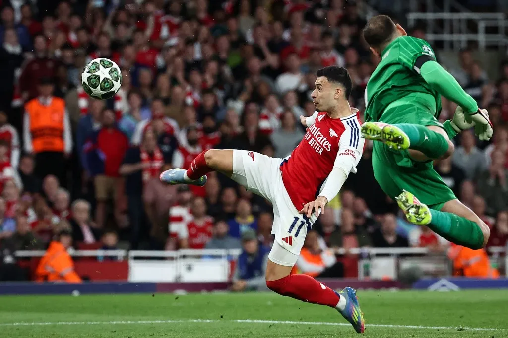 Arsenal's Brazilian midfielder #11 Gabriel Martinelli shoots the ball as Paris Saint-Germain's Italian goalkeeper #01 Gianluigi Donnarumma dives to try to stop the ball from entering the goal during the UEFA Champions League Semi-final First Leg football match between Arsenal and Paris Saint-Germain (PSG) at the Emirates Stadium in north London, on April 29, 2025. (Photo by FRANCK FIFE / AFP)