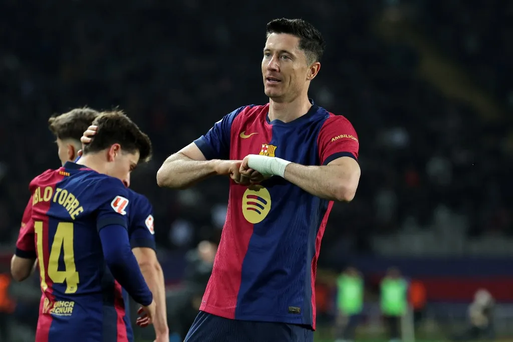 Barcelona's Polish forward #09 Robert Lewandowski celebrates after scoring his team's third goal during the Spanish league football match between FC Barcelona and CA Osasuna at Estadi Olimpic Lluis Companys in Barcelona on March 27, 2025. (Photo by LLUIS GENE / AFP)